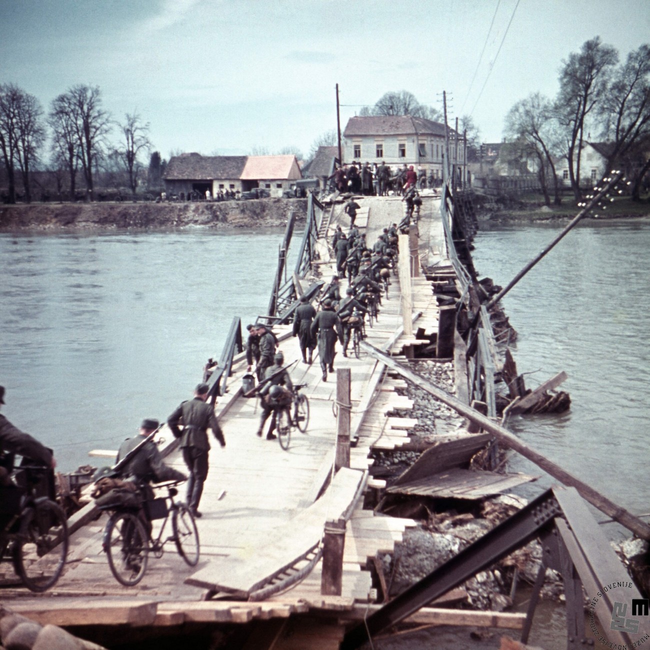 German Army crossing the Drava River across a demolished bridge, Ptuj, 1941. MNZS.