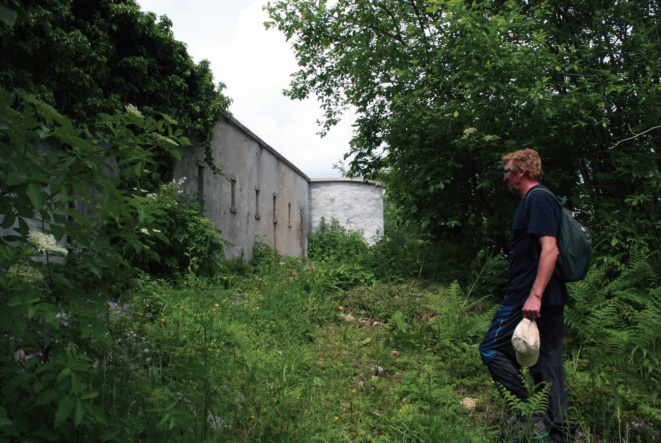 As part of the project, the recording of the remains of the border infrastructure is being carried out.The photograph shows the project’s leader Božo Repe, Ph. D., looking through the remains of border militia's barracks at Spodnji Vrsnik. Author of the photograph: Božidar Flajšman.