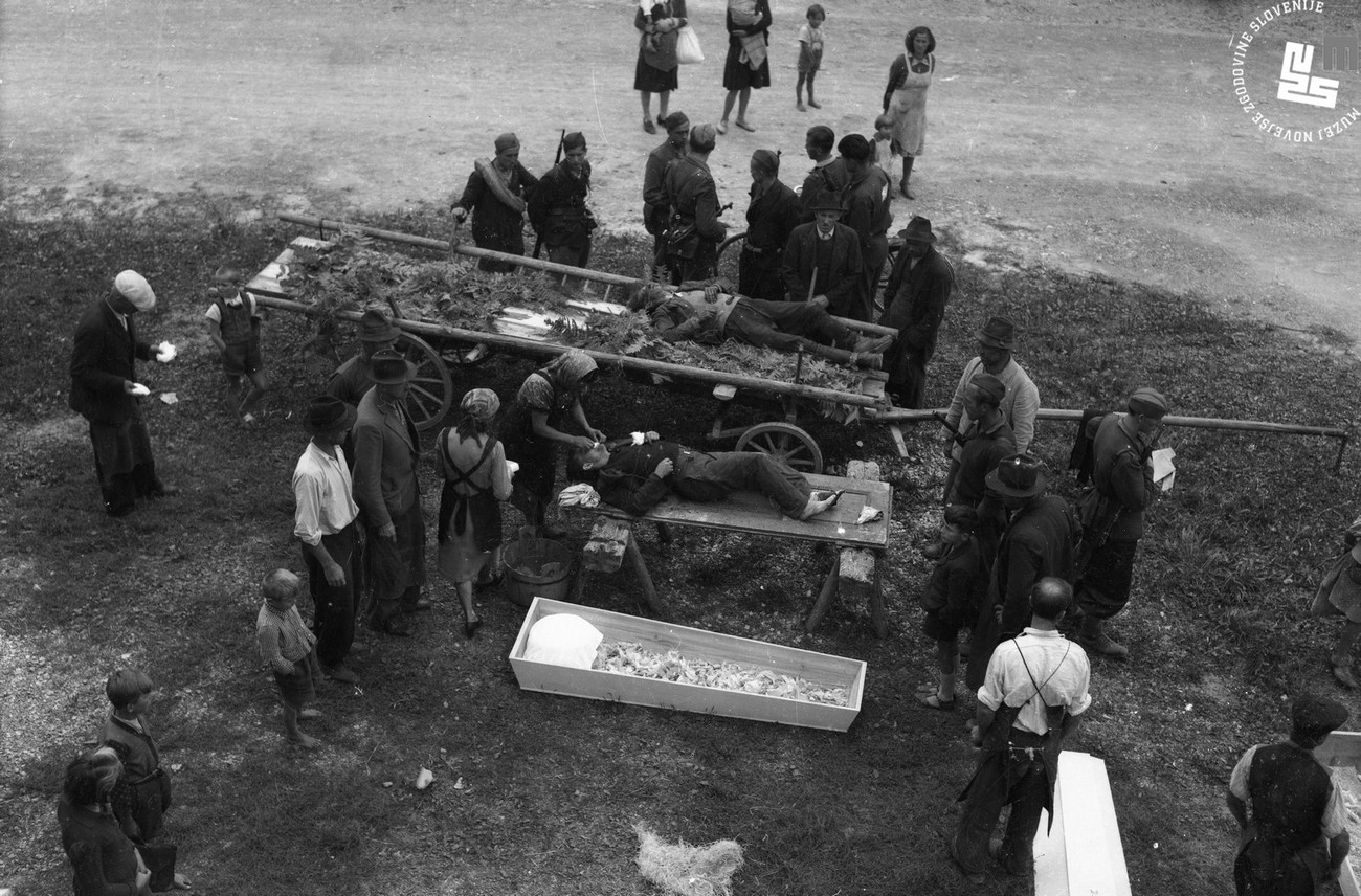 In the final years of the war, the population had to confront violence with an increased frequency. On 12 September 1944, Chetniks and Home Guard members from Vrh Svetih Treh Kraljev shot five hostages in Mršak. The selected photograph depicts the washing of one of the hostages before he was layed into his coffin. MNZS.